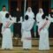 a group of people in white robes